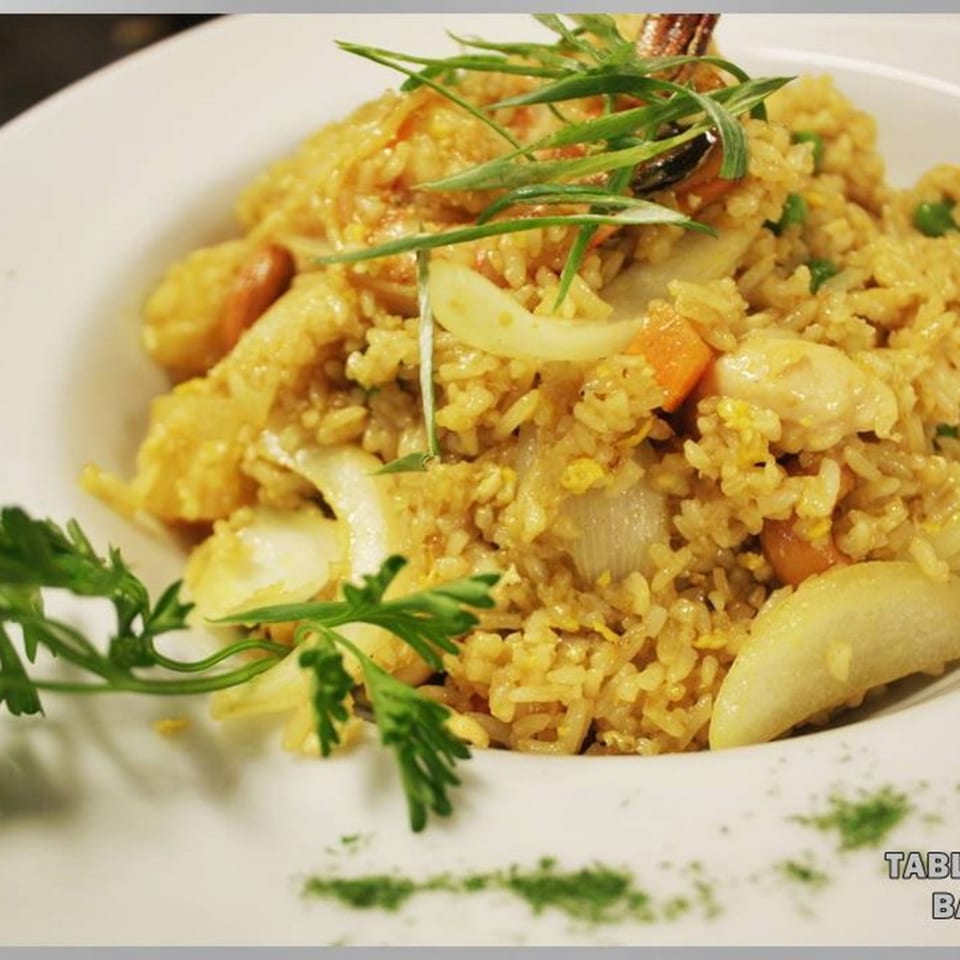 Close-up of Table Thai Bar & Bistro's fried rice with chicken, vegetables, and green onions.