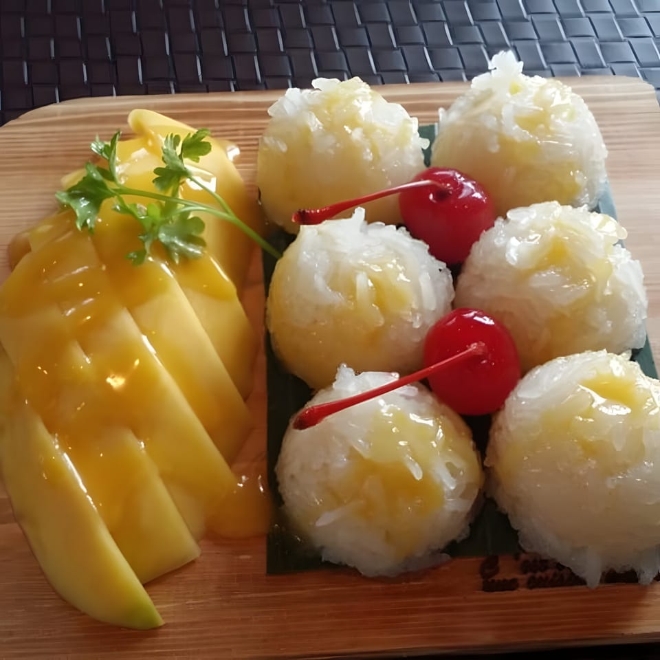 Table Thai Bar & Bistro's mango sticky rice dessert with fresh mango slices and sticky rice balls.