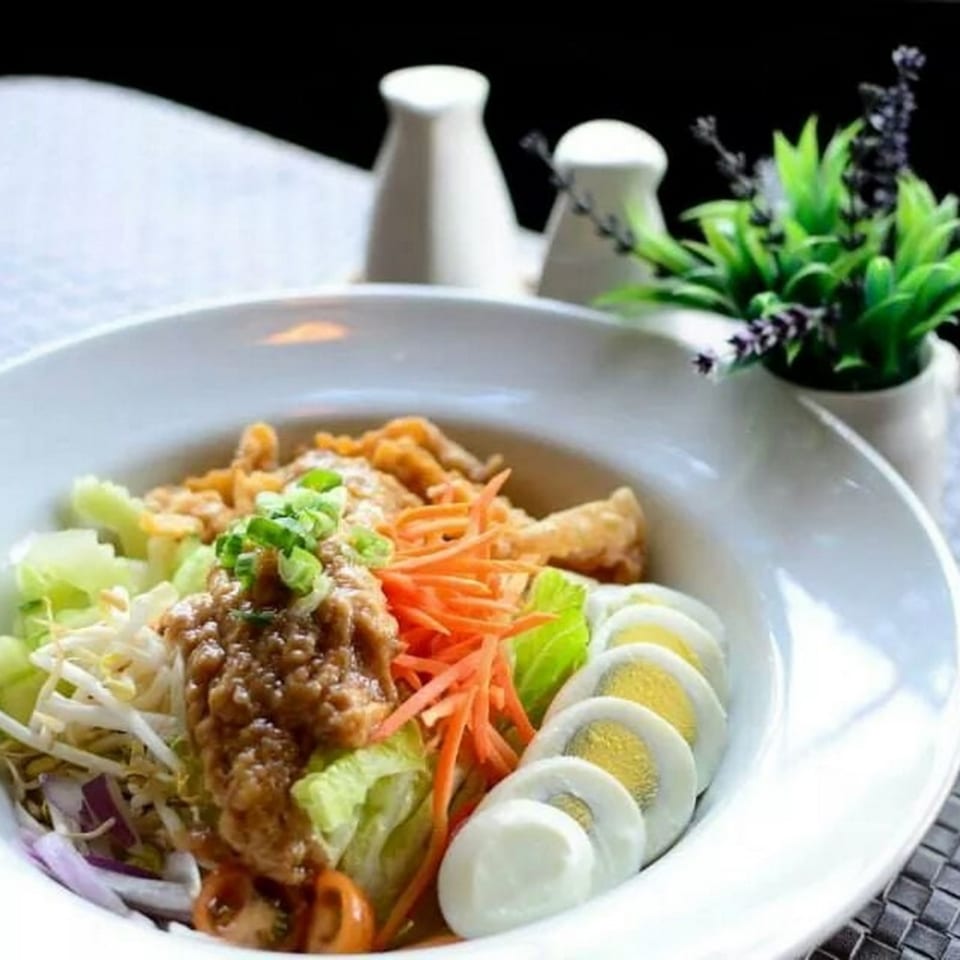 Table Thai Bar & Bistro's Thai salad with peanut dressing, eggs, and crispy chicken.